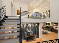 an open floor plan with stairs leading up to the second story