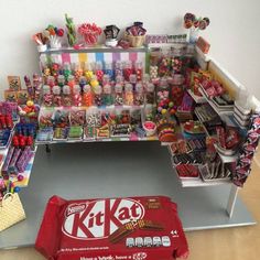 a kitkat candy stand filled with lots of candies and lollipops