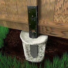 an image of a toilet in the grass under a wooden fence with its door open