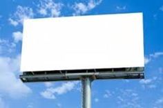 an empty billboard is shown against a blue sky with white clouds in the foreground