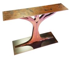 a metal table with a tree design on it