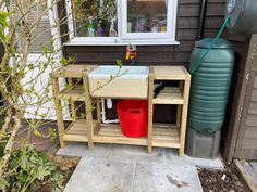 a sink and water tank in front of a house