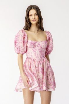 There’s more than a dash of old-time romance in the Tudor neckline, puffed sleeves and corset-style bodice of this mini-dress, but the sweet blossom print in shades of pink keeps it firmly in the present. The short, swingy skirt and wide, scooped back add to its charm. Self: 40% ramie, 30% lyocell, 30% cotton Lining: 100% cotton Made in China Hand wash Fully lined Exposed back zipper closure Boned bodice Puff sleeves with cinched cuffs Lightweight linen fabric with ruffle hem Dresses Tight, Corset Mini Dress, Dresses Pink, Dress 16, Hoco Dresses, Crop Top Blouse, Boho Maxi Dress, Puffed Sleeves, Dresses Short