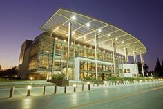 a large building lit up at night with lights on it's sides and windows