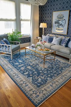 a living room filled with furniture and a blue rug