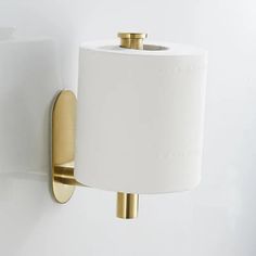 a toilet paper holder mounted to the side of a wall with a roll of toilet paper on it