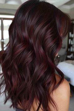 Dark, wavy hair with a deep burgundy tint, styled in loose curls. Bayalage Reddish Brown, Burgundy Balayage Hair, Cherry Highlights, Red Hair Colors, Balayage Hair Ideas, Burgundy Balayage, Red Violet Hair, Red Balayage Hair, Pepper Hair