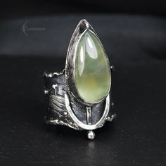 Modern, Brutalist-style Textured Ring. Fully handmade work. Sterling Silver and Silver Plated Brass.  The ring is covered with a protective layer. The main accent of this ring is a natural Prehnite. Material: Sterling Silver, Silver Plated Brass, Prehnite. The height of the central part is 3.7 cm. Size: Adjustable. Color: Silver, Green. Brutalist Jewelry, Texture Jewelry, Metal Jewellery, Hammered Ring, Mixed Metal Jewelry, Hammered Rings, Textured Ring, Jewelry Sterling Silver, Mixed Metals