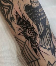 a tattoo on the arm of a man with an owl and spiderweave design