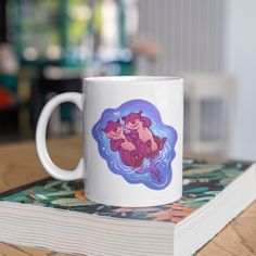 a white coffee mug sitting on top of a book