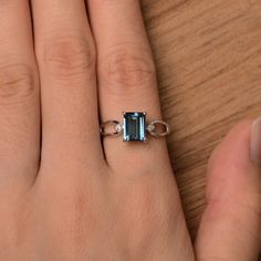 It is a London blue topaz ring. The main stone is 6 mm*8 mm emerald cut.weight about 2.01 carats. The basic metal is sterling silver and plated with rhodium. To change the metal to a solid gold (white/rose) or platinum is also available, please ask for a quotation if you want. You can also go to my shop Home for more elegant rings: https://www.etsy.com/shop/godjewelry?ref=hdr_shop_menu London blue topaz is November birthstone More London blue topaz rings: https://www.etsy.com/shop/godjewelry?ref Silver Emerald Cut Birthstone Ring, Emerald Cut Topaz Ring In Sterling Silver For Wedding, Wedding Emerald Cut Topaz Ring In Sterling Silver, Silver Sterling Emerald Ring With Baguette Cut, Silver Sterling Silver Emerald Ring Baguette Cut, Silver Sterling Silver Baguette Cut Emerald Ring, Silver Sterling Baguette Cut Emerald Ring, Sterling Silver Topaz Baguette Cut Ring Gift, Emerald Cut Topaz Ring In 14k White Gold