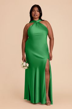 a woman wearing a green dress with high slit