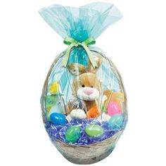 an easter basket filled with stuffed animals and colorful eggs in blue cellophane wrap