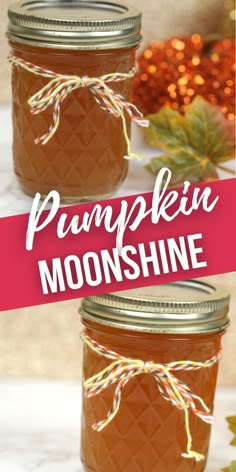 two mason jars filled with pumpkin moonhine sitting on top of a white tablecloth