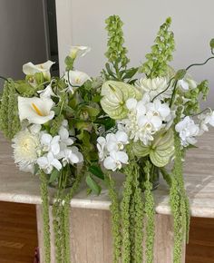 a vase filled with white flowers on top of a table