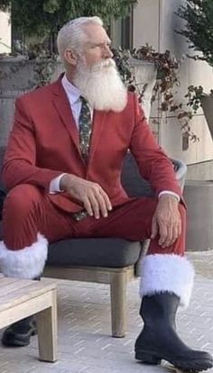 a man in a red suit sitting on a bench