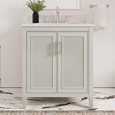 a bathroom with a sink, mirror and cabinet in it's centerpieces