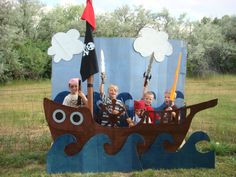 some kids are riding on a boat made out of cardboard