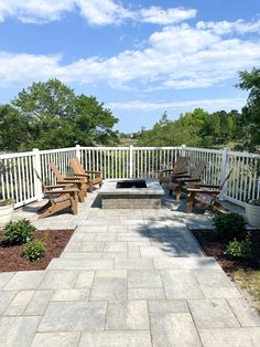 an outdoor patio with benches and fire pit