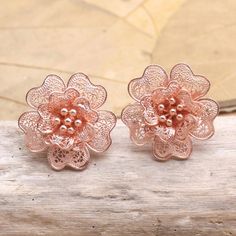 Delicate filigree and romantic rose gold make this pair of floral button earrings from Yuniati a must-have. The Balinese artisan hand crafts each petal from slender 18k rose gold-plated sterling silver wires that coil elegantly around the central beaded motif. Elegant Rose Gold Flower Clip-on Earrings, Filigree Flower Earrings, Rose Gold Bridal Earrings With Flower Shape As Gift, Rose Gold Bridal Earrings In Flower Shape As Gift, Rose Gold Flower Shaped Bridal Earrings For Gift, Rose Gold Rose Design Wedding Earrings, Feminine Rose Gold Bridal Earrings Gift, Rose Gold Flower Shape Bridal Earrings, Rose Gold Flower Bridal Earrings For Gifts