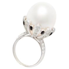 a white pearl and diamond ring