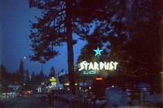 the stardust hotel sign is lit up at night