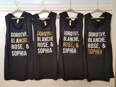 three black shirts hanging on a wall with the names of different people in white letters