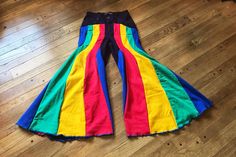 Rainbow bell bottoms, size Small. ❤️DESCRIPTION: One of a kind, 100% recycled. Go with the flow! 5 beautiful colors in these retro bell bottom pants: red, yellow, green, and blue on a deep purple background. Completely deconstructed and redesigned. Gorgeous reconstructed wide leg pants in cotton denim.  How will you rock them? 💛MEASUREMENTS: * Small, size 6 * 26.5 inch waist * 37.5 inch hips * 29 inch inseam * 100% recycled cotton 💚SHIPPING: Immediate shipping worldwide; buy with confidence. ? Hippie Style Multicolor Flare Bottoms, Multicolor Flare Hippie Bottoms, Retro Flare Bottoms For Festival, Multicolor Flare Cotton Bottoms, Multicolor Flare Pants For Festival, Multicolor Cotton Flare Bottoms, Flare Multicolor Pants For Festival, Festival Flare Cotton Pants, Cotton Flare Pants For Festivals