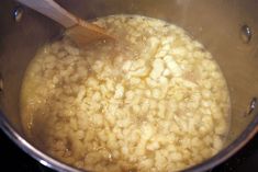 the food is being cooked in the pot on the stove