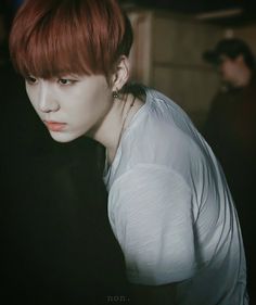 a young man with red hair and piercings