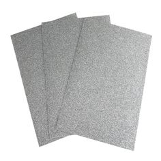 three pieces of silver glitter paper on a white background