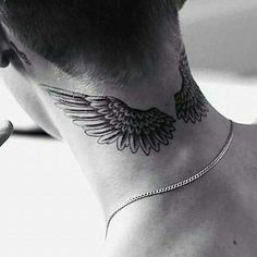 a man's neck with an angel wing tattoo on the side of his neck