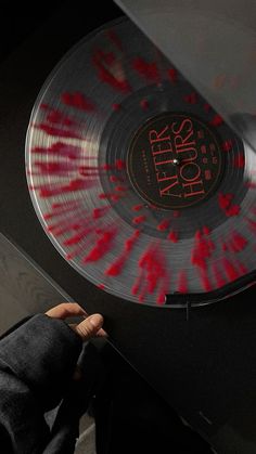 a person holding a record with blood on it