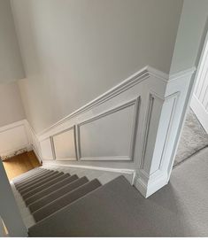 an empty room with stairs and carpeted flooring