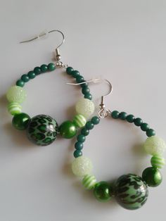 Small green leopard print beaded hoop earrings made with a green leopard print middle bead with a mix of other green beads to compliment. Hoops are 2.5 inches in length, starting from top of fish hook. Light weight with nickel free fish hooks!  Thanks for looking..🙂 Trendy Green Dangle Hoop Earrings, Handmade Adjustable Green Hoop Earrings, Adjustable Handmade Green Hoop Earrings, Green Beaded Hoop Earrings For Gift, Adjustable Green Hoop Earrings, Green Beaded Dangle Hoop Earrings, Handmade Green Beaded Hoop Earrings, Trendy Green Beaded Dangle Earrings, Trendy Green Beaded Drop Earrings