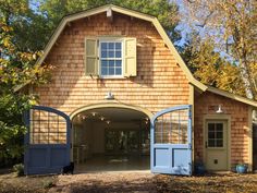 an open garage door on the side of a wooden building