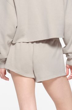 Keep your look laid-back and luxe in casual sweat shorts made from supersoft cotton-blend fleece in a relaxed fit brought to you by Kim Kardashian's SKIMS. 3" inseam; 28" leg opening; 10 1/2" front rise; 16" back rise (size Medium) Elastic waist 70% cotton, 30% polyester Machine wash, tumble dry Imported