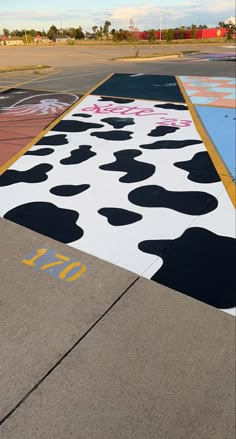 an empty parking lot painted with black and white spots