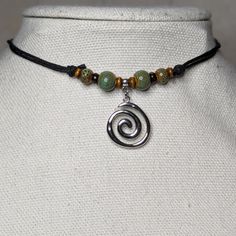 Green Ceramic Beaded Silver Spiral Swirl Charm Boho Hippie Adjustable Black Rope Cord Choker Stacking Necklace Comes On An Adjustable Waxed Black Cord Necklace. Necklace Is Adjustable From Approximately 13" To 22". Layering Necklaces Hack, Gifts For Hippie Friends, Safety Pin Choker, Hemp Cord Jewelry, Silver Hippie Jewelry, Swirly Necklace, Necklace Boho, Taino Jewelry, Earthy Necklace Aesthetic