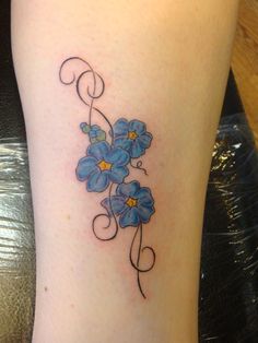 a blue flower tattoo on the leg