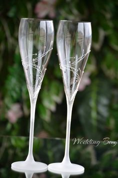 two wine glasses sitting next to each other