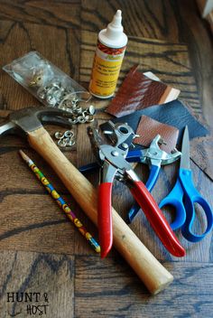 some tools are laying on top of a wooden table