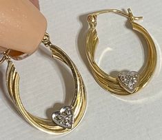 "Beautiful 14K Yellow Gold 1\" Diamond Heart Hoop Earrings Beautiful hoop earrings with a heart on bottom of hoop with genuine diamonds! Earrings measure approximately 1\" long x 6/8\" wide. Weight is 2.2 grams Absolutely beautiful! Please message me with any questions Shipped insured in a gift box I guarantee item to be exactly as described and pictures." Heart-shaped Fine Jewelry Hoop Earrings For Anniversary, Small Hoop Earrings For Anniversary On Valentine's Day, Anniversary Heart-shaped Fine Hoop Earrings, Pierced Hoop Heart Earrings For Anniversary, Small Hoop Earrings For Valentine's Anniversary, Anniversary Heart-shaped Hoop Earrings With Heart Charm, 14k Gold Heart-shaped Hoop Earrings For Anniversary, Hoop Earrings For Valentine's Day Anniversary, Valentine's Day Hoop Earrings For Anniversary