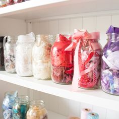 many jars filled with different types of candy