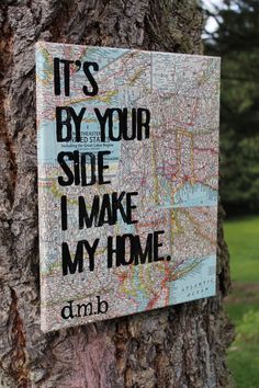 a sign on a tree that says it's by your side i make my home