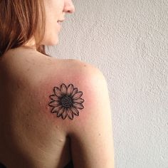 a woman with a sunflower tattoo on her shoulder