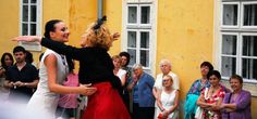 two women are dancing in front of a group of people