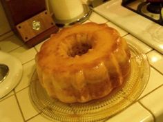 a glazed donut sitting on top of a glass plate