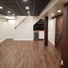 an empty room with hard wood floors and white walls