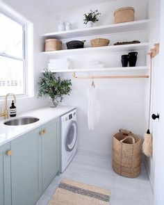 a washer and dryer in a small room with shelves above the washer